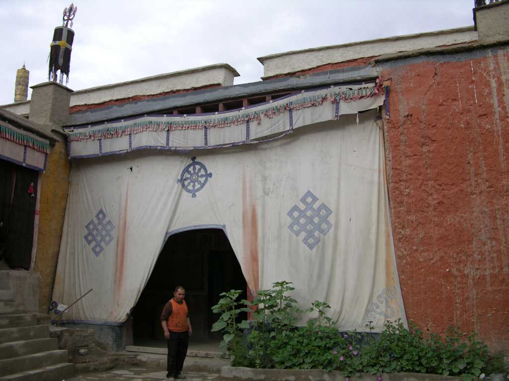 Tibet Guge 03 Tholing 03 Red Temple Entrance The monk brought us a powerful flashlight to see the paintings inside the Red Temple.